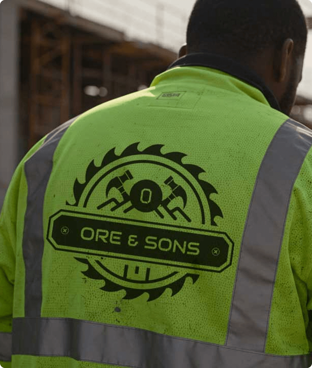 a man wearing a reflective jacket, turning his back.